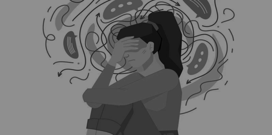 woman sitting on the floor holding her hand over her face